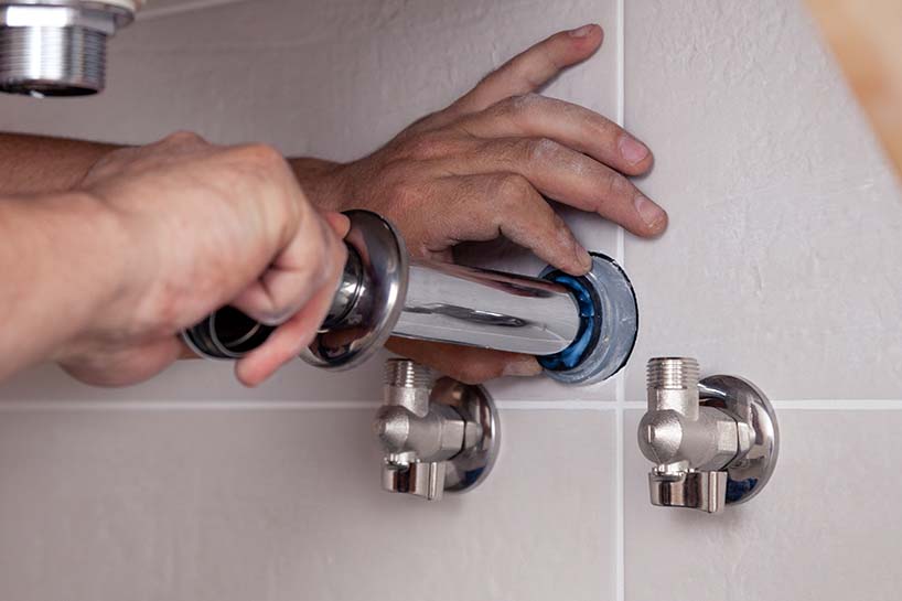 photo of a plumber installing a new pipe